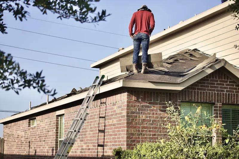 Professional roofer working on a residential roof in Stanleyville